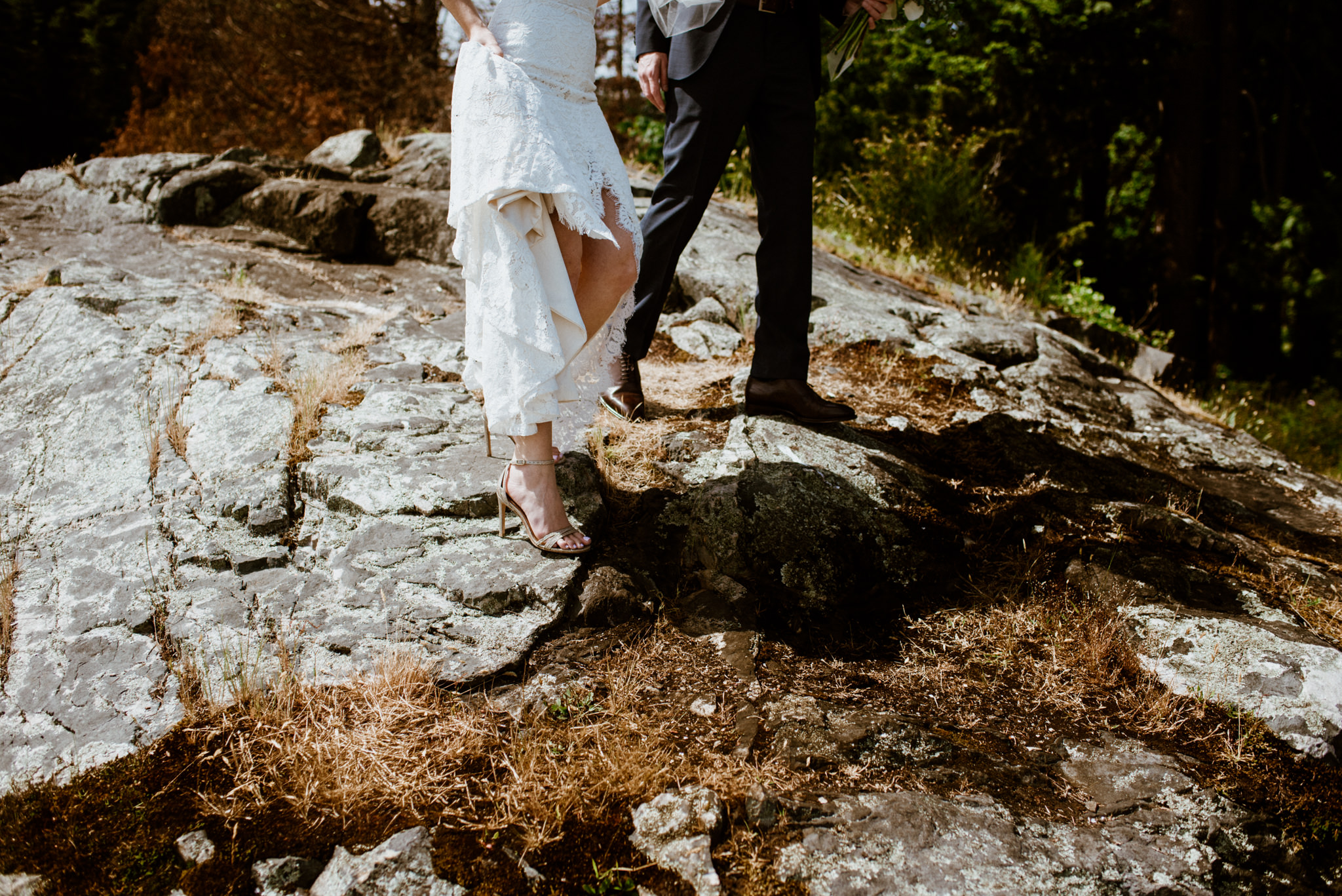 Bride and groom standing on rocks before wedding reception at Homer Street Cafe Yaletown Vancouver